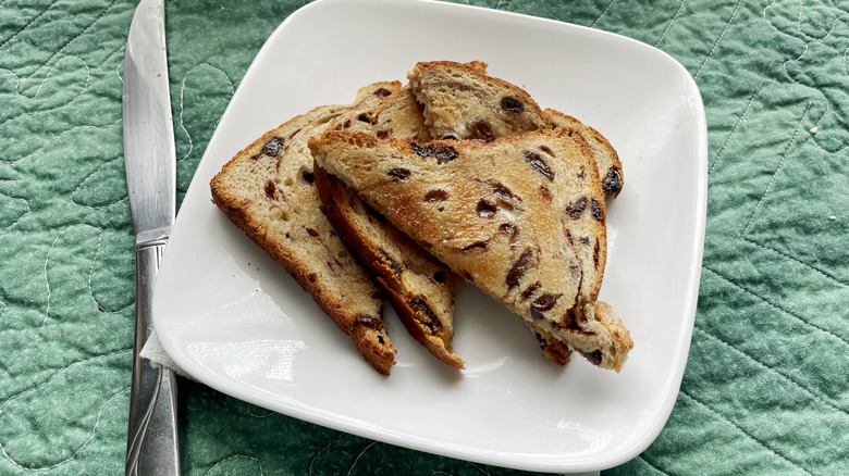 sliced toasted raisin bread on a square white plate