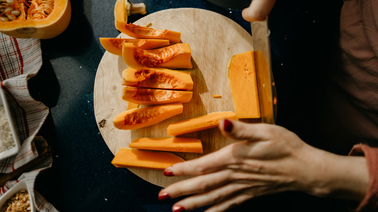 hands chop up butternut squash