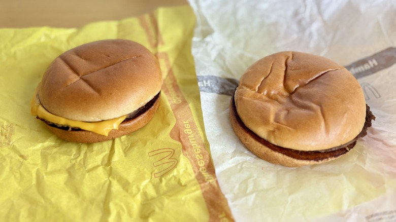 Cheeseburger sitting beside a Hamburger