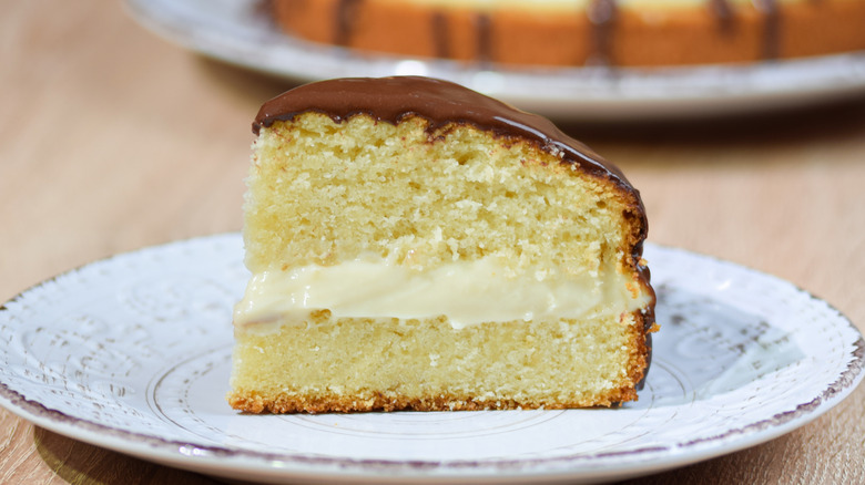 closeup of sliced Boston cream pie on white plate