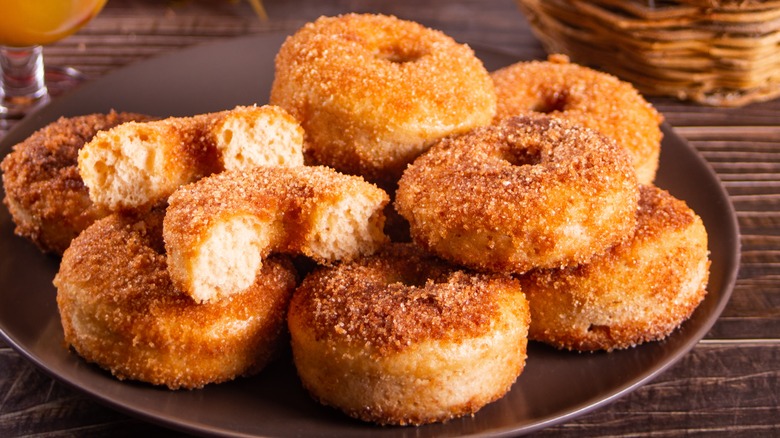 pile of apple cider donuts on brown plate