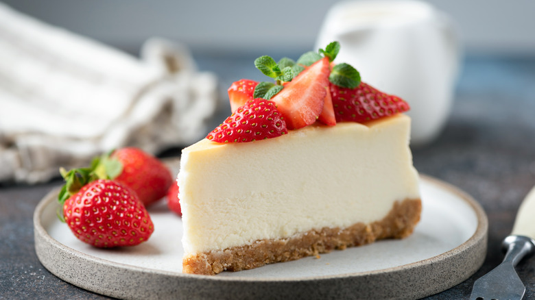 closeup slice of cheesecake with strawberries