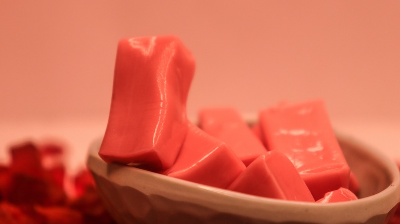 pink Starburst candies unwrapped in a bowl