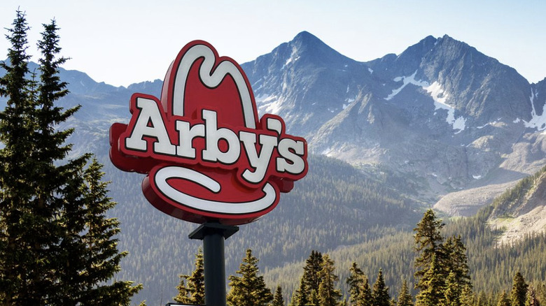 Arby's sign with mountain backdrop