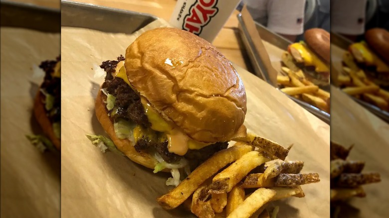 mooyah burger with fries and cup