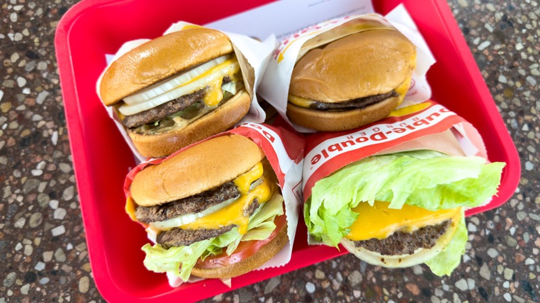 four in-n-out burgers on tray