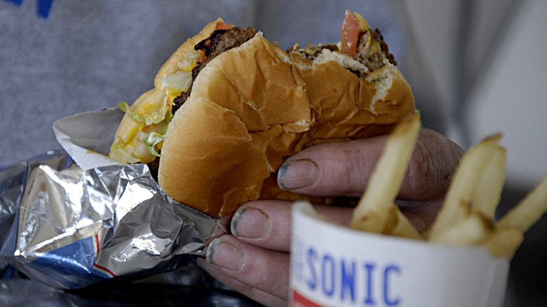 hand holding sonic burger