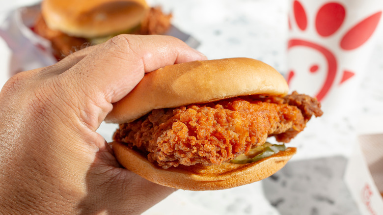 Hand holding Chick-fil-A sandwich