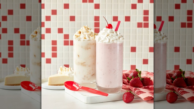 Two milkshakes with spoon berries