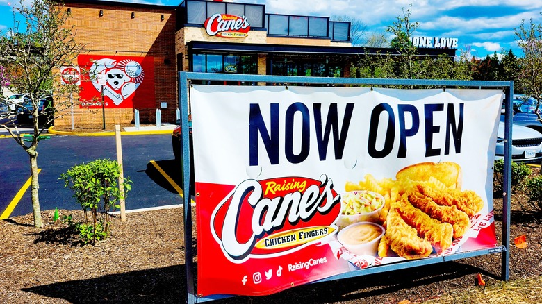 raising cane's now open sign