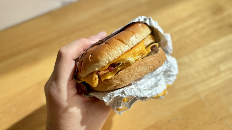 Hand holding a Wendy's Breakfast Baconator