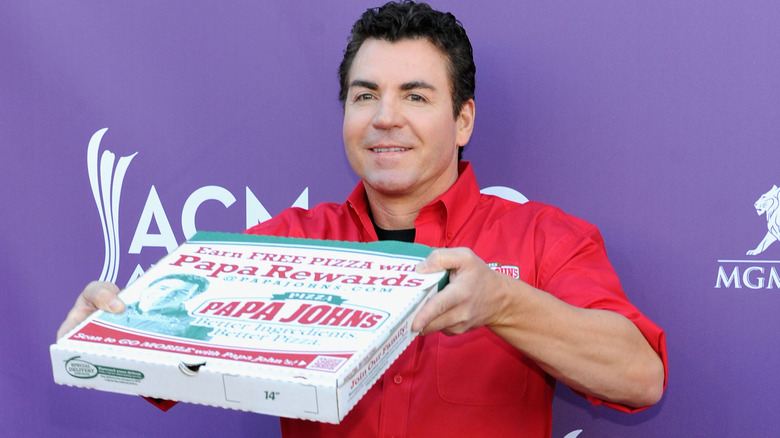 john schnatter holding papa john's box