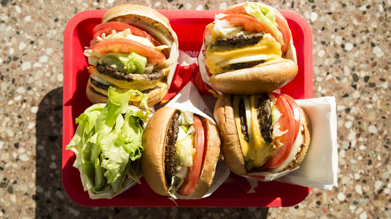 Tray of burgers on table