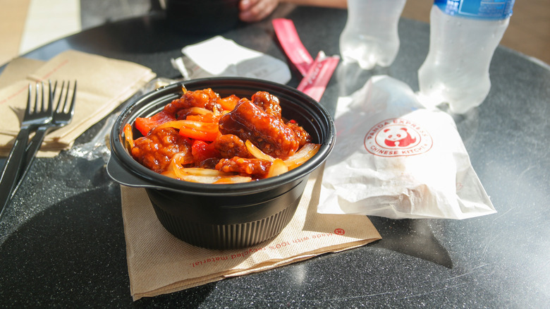 Food from Panda Express on table with forks and napkins