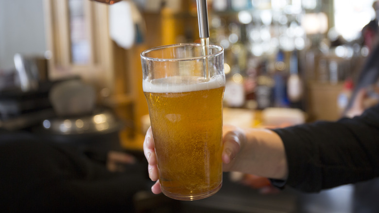 A pint of beer being poured.