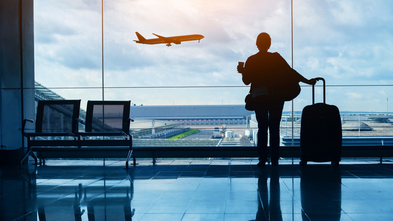 A person watching a plane fly past.