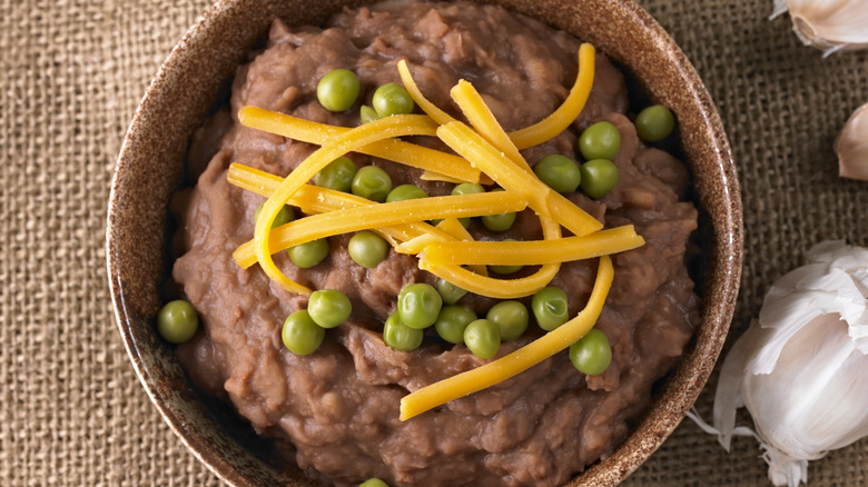 Refried beans with cheese and peas