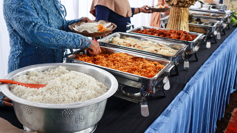 Buffet table with various dishes and no glass barrier