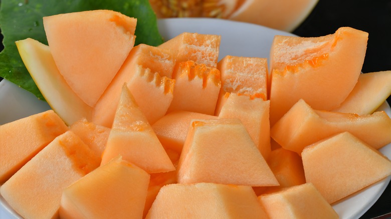 Precut cantaloupe on white plate