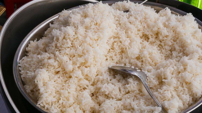 Pot of white rice with metal spoon