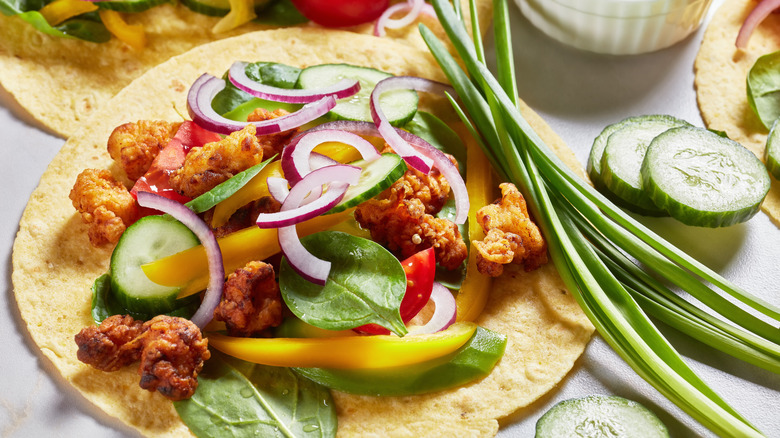 Close-up of taco with fried chicken and fresh vegetables