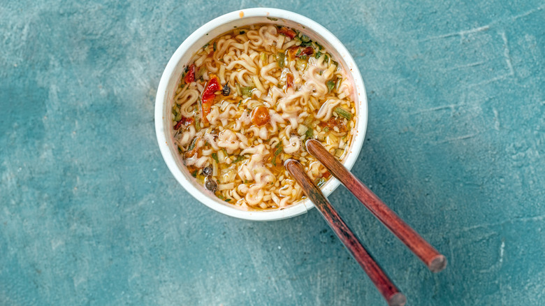 A bowl of ramen with wooden chopsticks