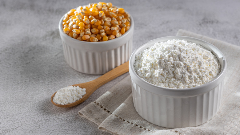 Bowls of cornstarch and whole, dried corn kernels