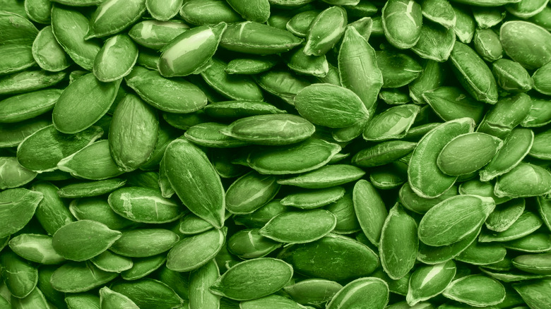 A big pile of green unripe pumpkin seeds