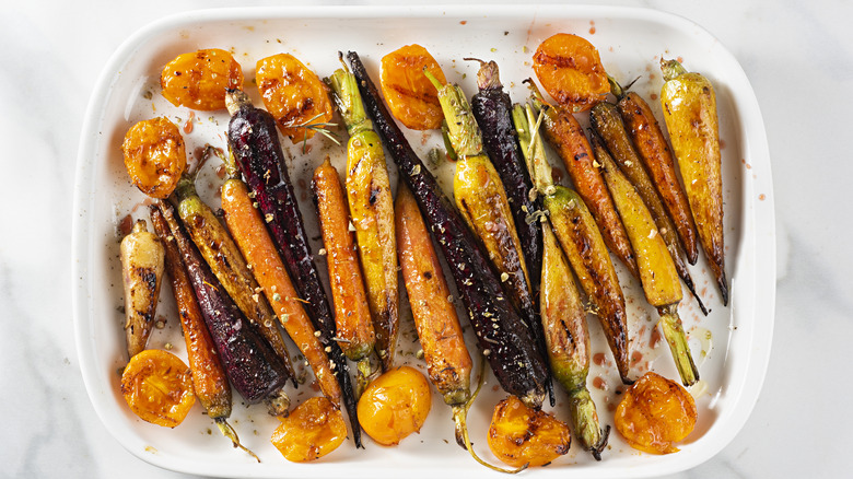 roasted carrots, purple carrots and tomatoes