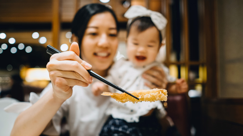 Mother and child eating tempura