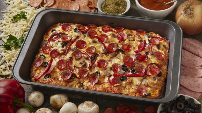 A square pizza in a pan with pepperoni and olives