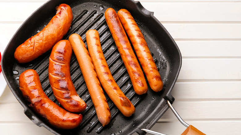 Seared hot dogs in a cast iron grill pan