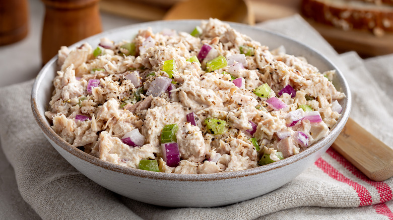 A bowl of tuna salad with chopped onions and celery