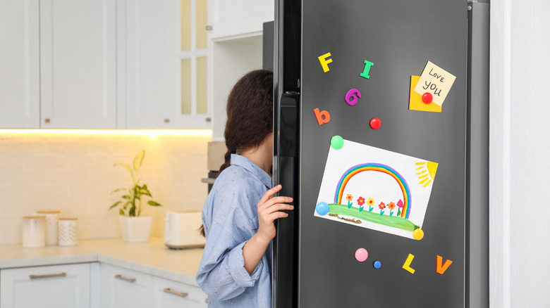 women opening fridge