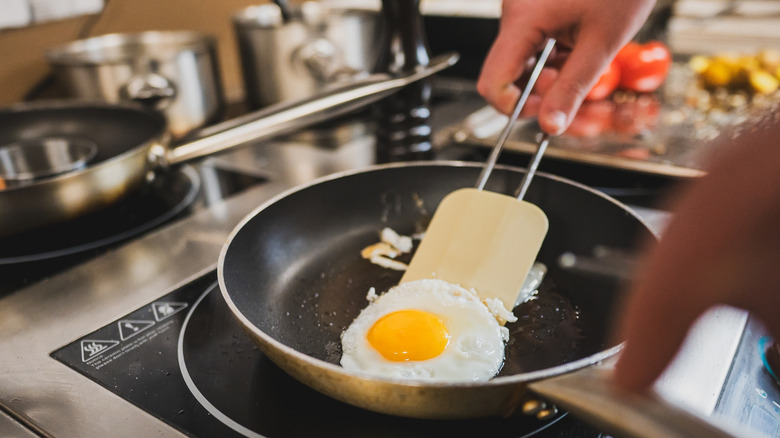 Flipping an egg with a spatula