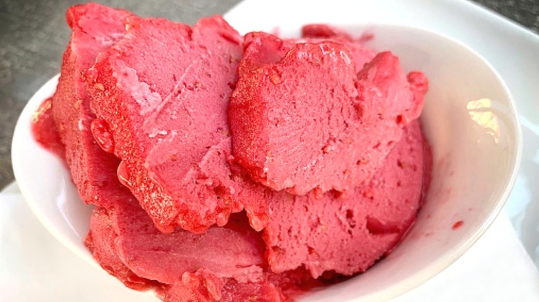 A white bowl of raspberry gelato