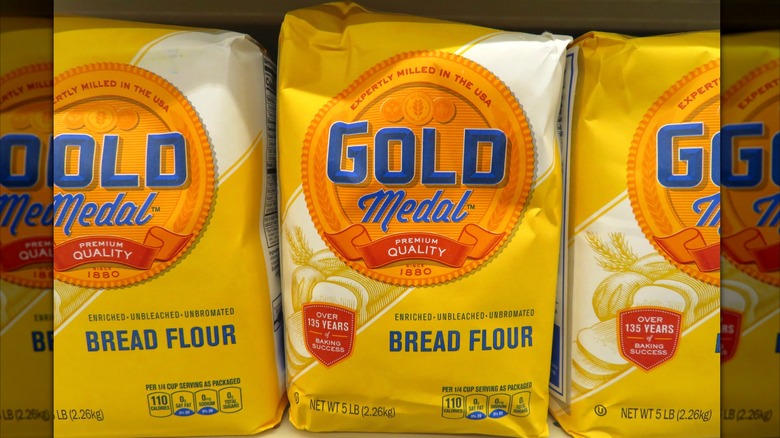 Yellow Gold Medal Unbleached Bread Flour in five-pound bag on store shelf