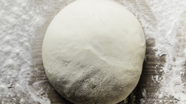 pizza dough on a floured surface