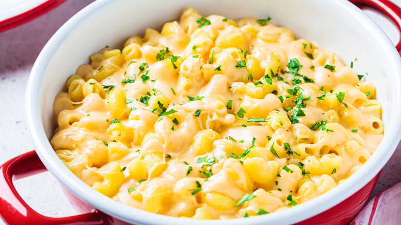 A pot of macaroni and cheese sitting on a table.