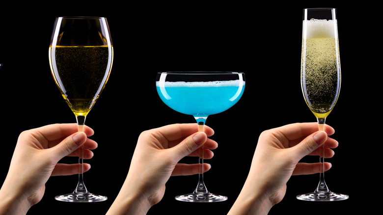 Hands holding flutes of sparkling wine and Tiffany mimosa in coupe glass