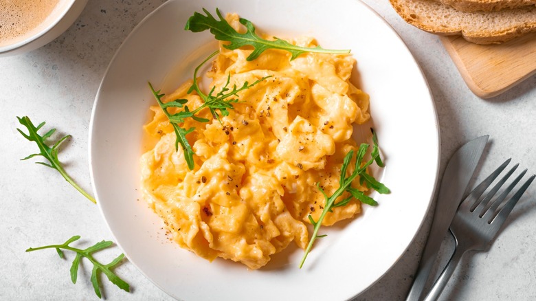 Scrambled eggs served on a white plate