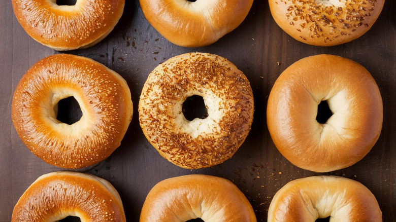 overhead shot of a variety of bagels against a dark background