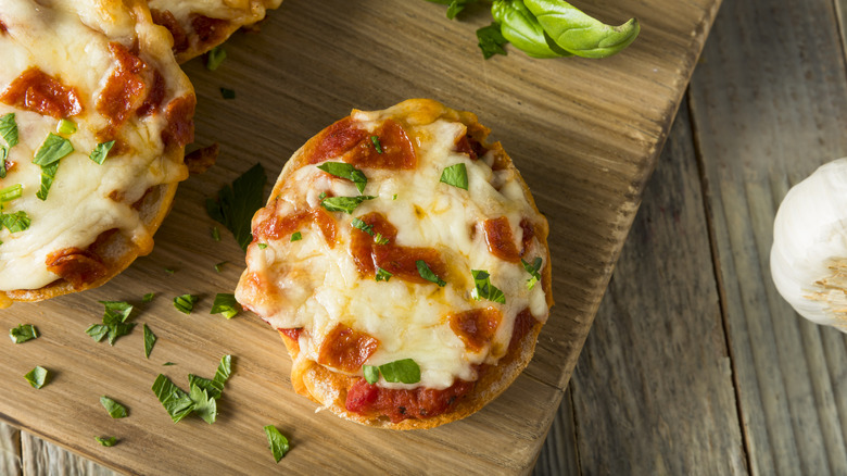 overhead view of pizza bagels garnished with basil