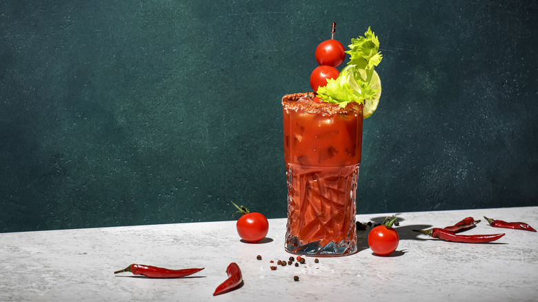 A Bloody Mary cocktail with tomato, lemon, and celery garnishes