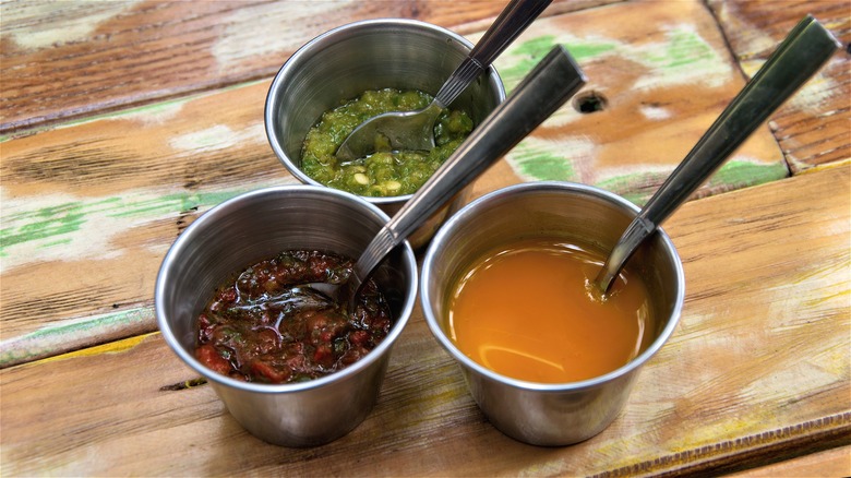 three toppings in metal bowls