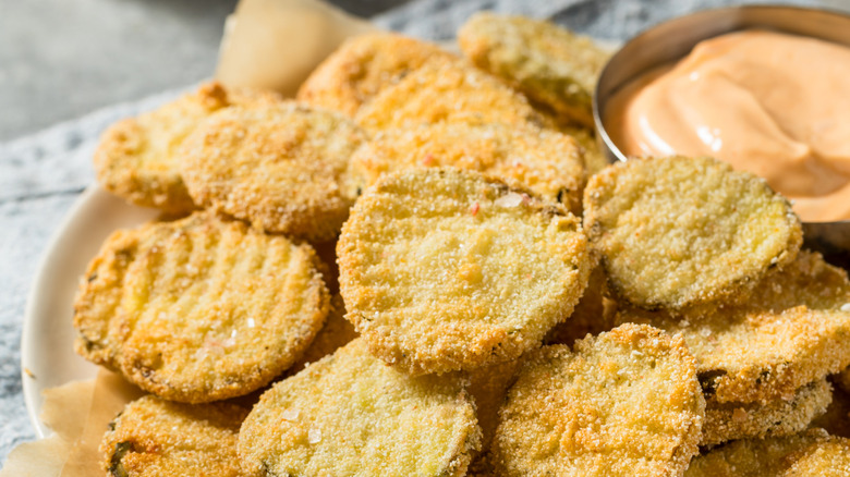 A plate of fried pickles on a white plate