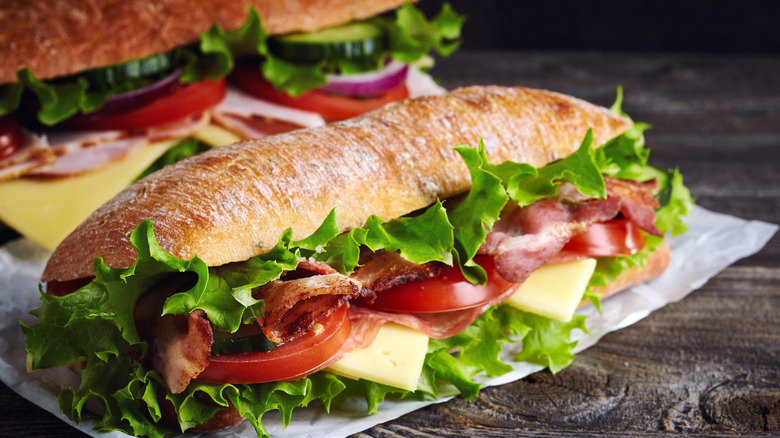 Two sub sandwiches on parchment paper