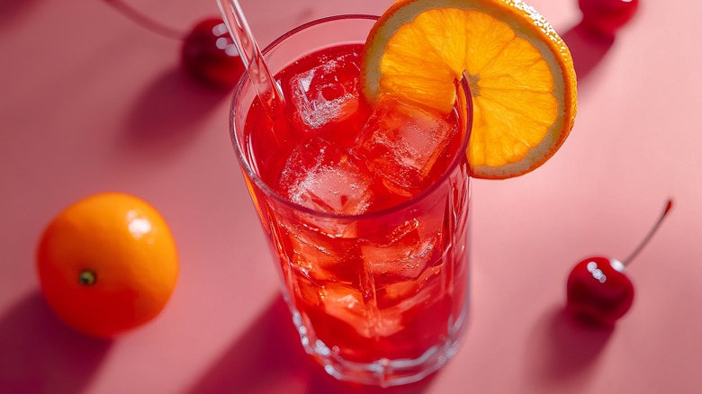 Close up of a Shirley Temple with cherries and an orange