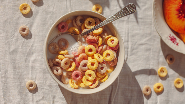 A bird's eye view of a bowl of cereal with milk and a spoon