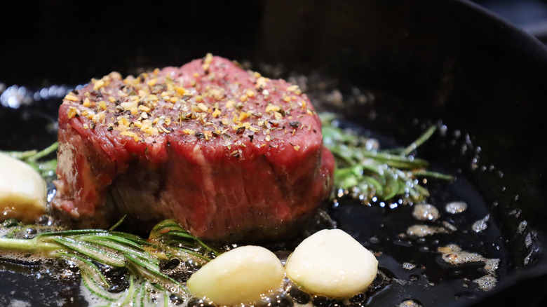 filet mignon steak  searing with herbs and garlic